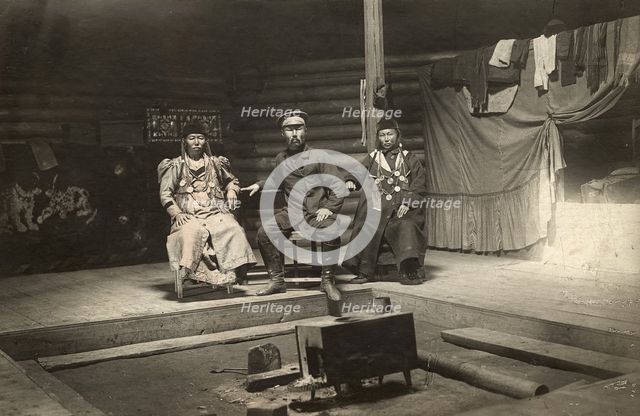 The interior of a Buryat yurt. In the center is a householder with two wives, 1905. Creator: L Veniukov.
