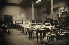 The interior of a dissecting room in Edinburgh, with half-covered cadavers on benches, 1889. Creator: Unknown