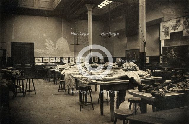 The interior of a dissecting room in Edinburgh, with half-covered cadavers on benches, 1889. Creator: Unknown.
