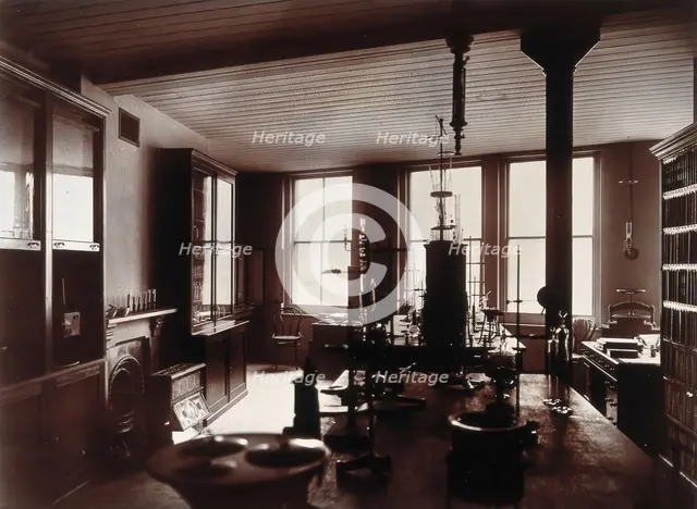 The interior of a pharmaceutical or chemical laboratory, with two long benches in the centre, glass. Creator: Unknown.