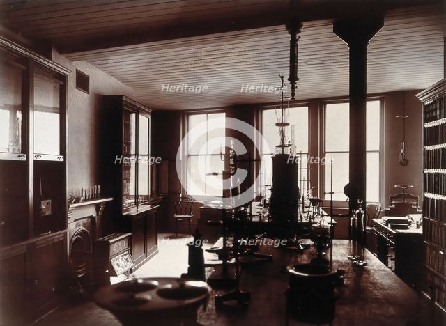 The interior of a pharmaceutical or chemical laboratory, with two long benches in the centre, glass. Creator: Unknown.