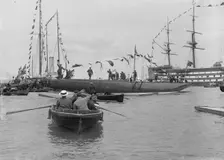 The launch of Shamrock IV with H.M.S. Victory in the background, May 1914. Creator: Kirk & Sons of Cowes