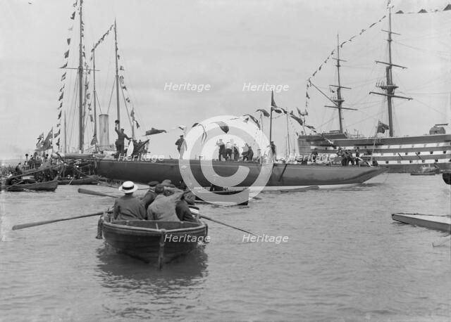 The launch of 'Shamrock IV' with H.M.S. Victory in the background, May 1914. Creator: Kirk & Sons of Cowes.