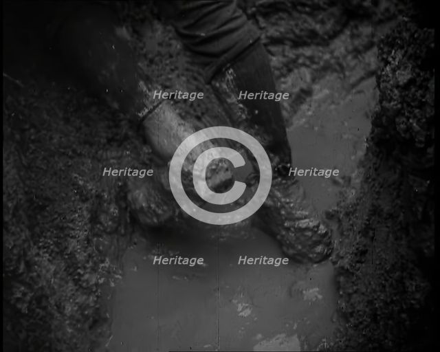 The Legs and Boots of a Male French Soldiers as He is Standing in a Water-Logged Muddy Trench, 1939. Creator: British Pathe Ltd.