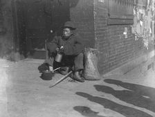 The paper gatherer, Chinatown, San Francisco, between 1896 and 1906. Creator: Arnold Genthe