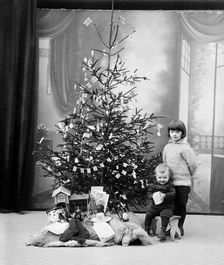 The photographer's children and their Christmas presents, Sweden. Creator: Unknown