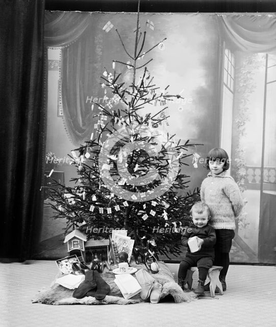 The photographer's children and their Christmas presents, Sweden. Creator: Unknown.