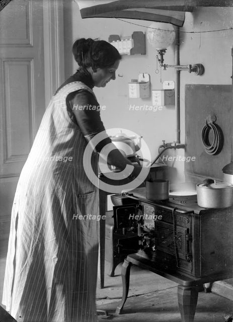The photographer's wife in the kitchen, Landskrona, Sweden, 1910. Creator: Unknown.