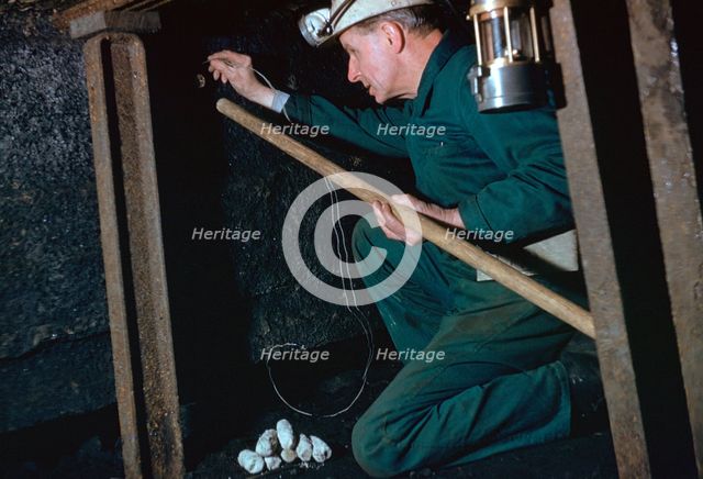 The Pit Deputy prepares for shot firing.