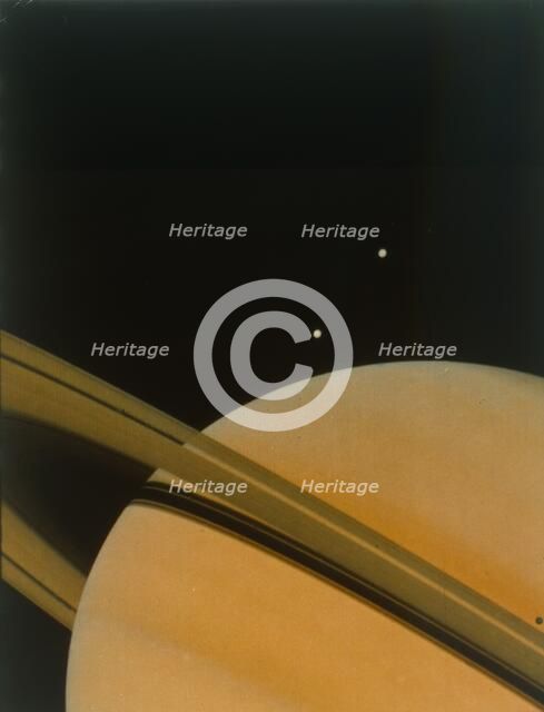 The planet Saturn with moons Tethys and Dione. Creator: NASA.