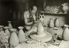 The Potter at his Wheel 1910. Creator: Herbert Ponting
