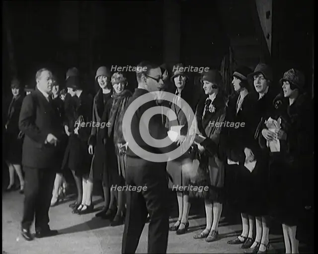 The Producer Julian Wylie Inspecting Young Prospective Female Stage Performers Standing..., 1920s. Creator: British Pathe Ltd.