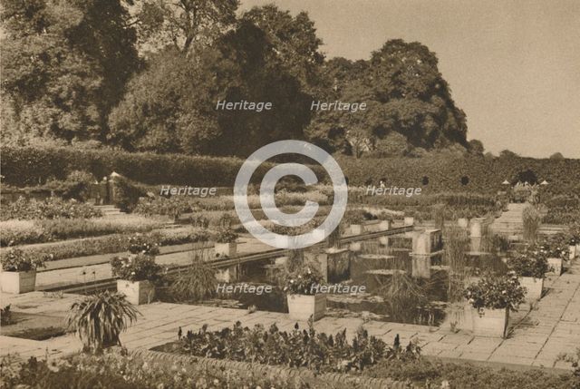 'The Quiet of the Dutch Garden at Kensington Palace Guarded By Locked Gates', c1935. Creator: Unknown.