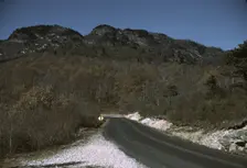 The road along the Skyline Drive, with a light snowfall in the rocks beside, Virginia, ca. 1940. Creator: Jack Delano