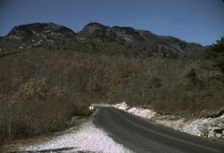 The road along the Skyline Drive, with a light snowfall in the rocks beside, Virginia, ca. 1940. Creator: Jack Delano