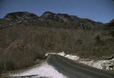 The road along the Skyline Drive, with a light snowfall in the rocks beside, Virginia, ca. 1940. Creator: Jack Delano