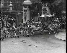 The Royal Coach, Horses, and Procession Filing Out of the Gates at the Front of Buckingham..., 1937. Creator: British Pathe Ltd