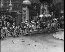 The Royal Coach, Horses, and Procession Filing Out of the Gates at the Front of Buckingham..., 1937. Creator: British Pathe Ltd