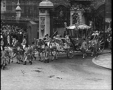 The Royal Coach, Horses, and Procession Filing Out of the Gates at the Front of Buckingham..., 1937. Creator: British Pathe Ltd