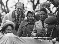 The Royal family watch a portable television at the Badminton Horse Trials, 1973