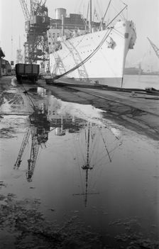 The Strathaird reflected in a puddle at Tilbury Docks, Essex, c1945-c1965. Artist: SW Rawlings