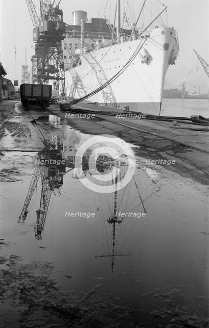 The 'Strathaird' reflected in a puddle at Tilbury Docks, Essex, c1945-c1965. Artist: SW Rawlings