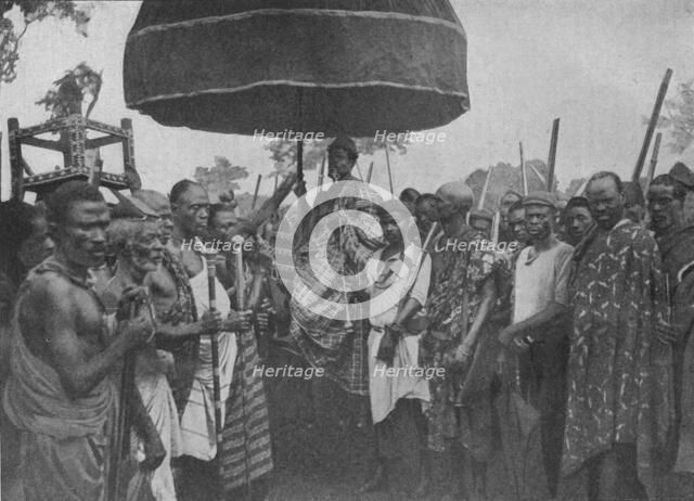 'The Subdued King of Akim Carried on his Chair of State', 1902. Artist: Unknown.
