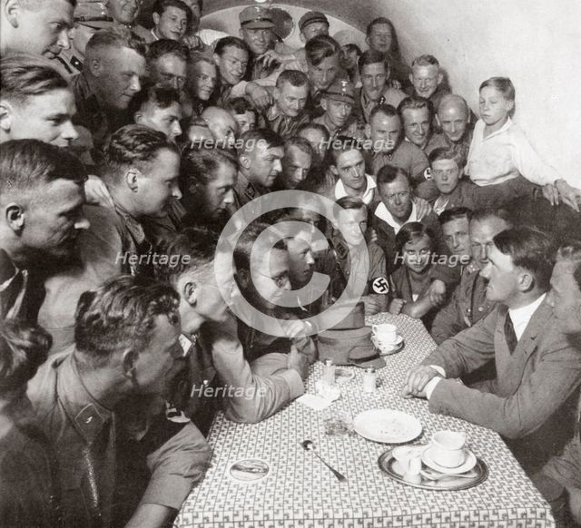 'The supreme SA leader Adolf Hitler with his comrades', 1938.  Creator: Unknown.