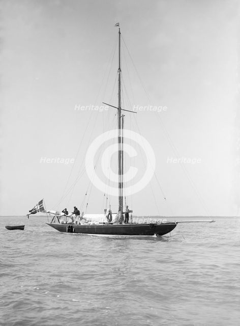 The sailing yacht 'Rollo' at anchor, 1911. Creator: Kirk & Sons of Cowes.
