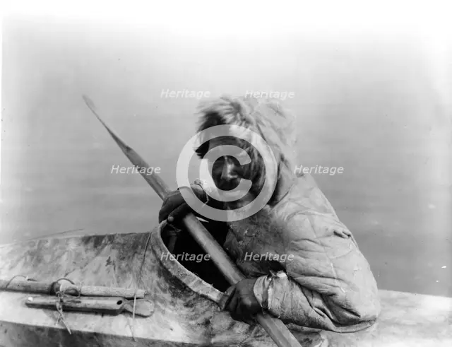 The seal-hunter, Noatak, in kayak, facing left, c1929. Creator: Edward Sheriff Curtis.