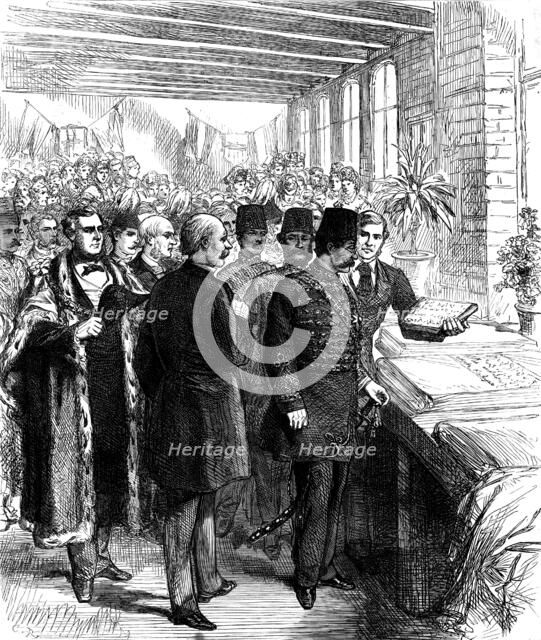 The Shah at Manchester: inspecting a piece of calico printed with Persian words of welcome, 1873. Creator: Unknown.
