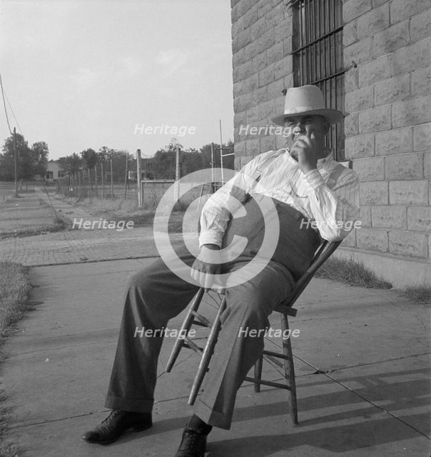 The sheriff of McAlester, Oklahoma, sitting in front of the jail, 1936. Creator: Dorothea Lange.