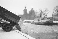 The snow clearance squad tip snow into the harbour, Landskrona, Sweden 1958