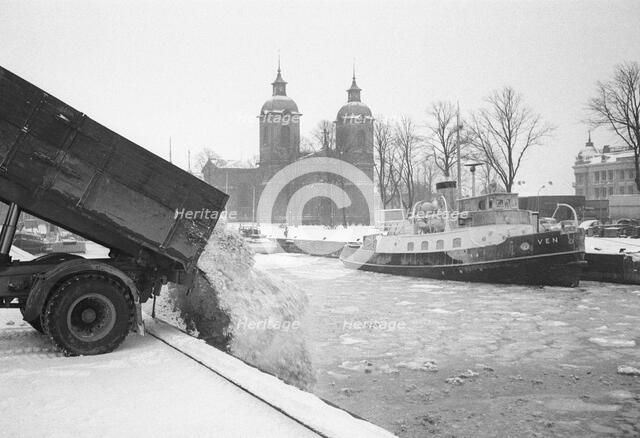 The snow clearance squad tip snow into the harbour, Landskrona, Sweden 1958. Artist: Unknown