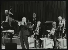 The Ted Heath Orchestra in concert, London 1985. Pictured are Lennie Bush (double bass), Kenny Baker Creator: Denis Williams