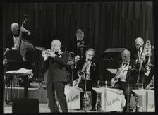 The Ted Heath Orchestra in concert, London 1985. Pictured are Lennie Bush (double bass), Kenny Baker Artist: Denis Williams