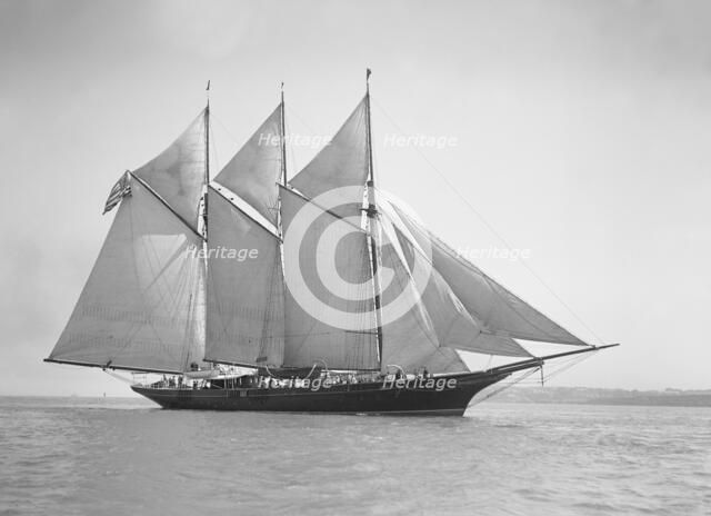 The three-mast auxiliary schooner 'Invincible', 1911. Creator: Kirk & Sons of Cowes.