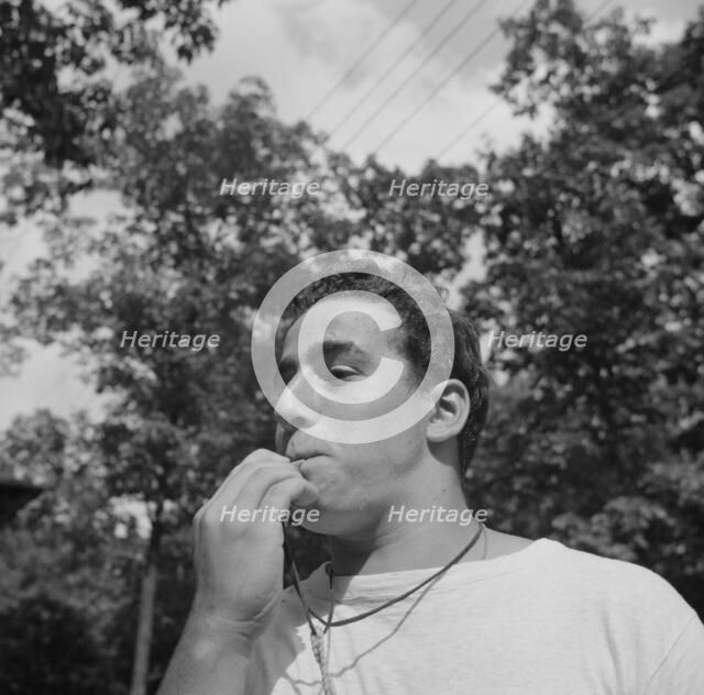 The town crier, Danny Poocchiari., Camp Nathan Hale, Southfields, New York, 1943 Creator: Gordon Parks.