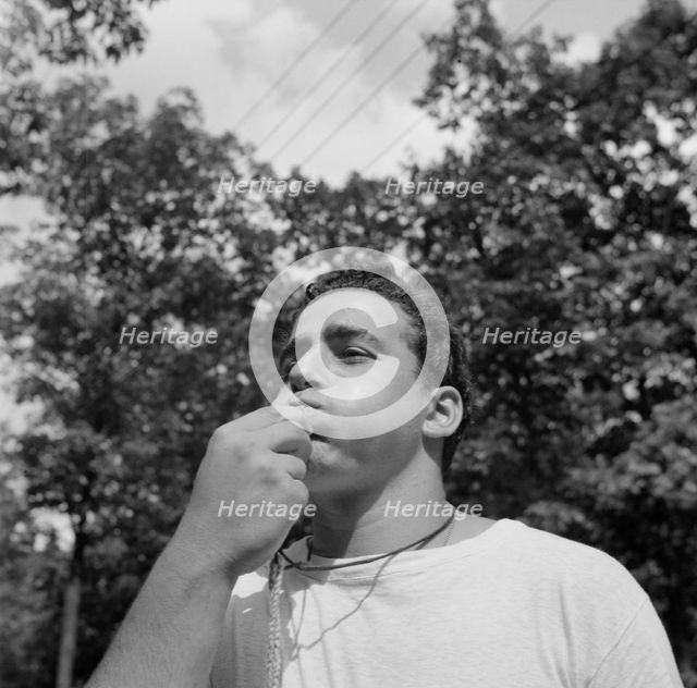 The town crier, Danny Poocchiari., Camp Nathan Hale, Southfields, New York, 1943 Creator: Gordon Parks.