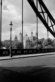 The Tower of London, viewed here through the cable supports of Tower Bridge, c1945-c1965. Artist: SW Rawlings