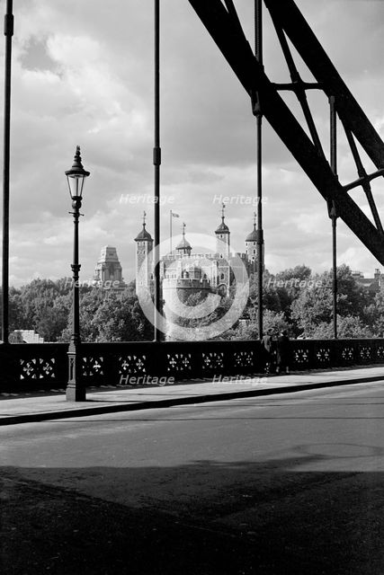 The Tower of London, viewed here through the cable supports of Tower Bridge, c1945-c1965. Artist: SW Rawlings