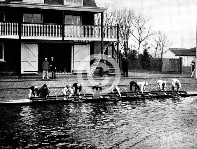 The Universities' Boat-Race: the Cambridge crew at practice - putting in the boat, 1895. Creator: Stearn.
