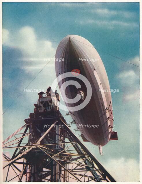 The US airship 'Macon' being moored to the mobile mast at Lakehurst, New Jersey, c1935 (c1937). Artist: Unknown.