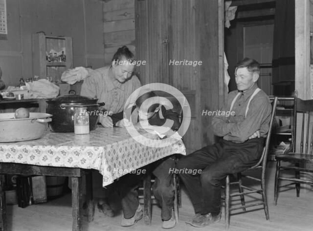 The Wardlow family in their dugout basement home on Sunday, Dead Ox Flat, Oregon, 1939. Creator: Dorothea Lange.
