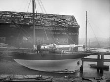 The yawl Banzai dried out at boatyard mooring, 1912. Creator: Kirk & Sons of Cowes