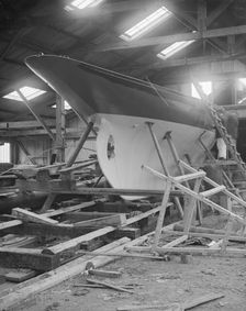The yawl Banzai in shed at boatyard, 1912. Creator: Kirk & Sons of Cowes