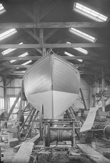 The yawl Banzai in shed at boatyard, 1912. Creator: Kirk & Sons of Cowes