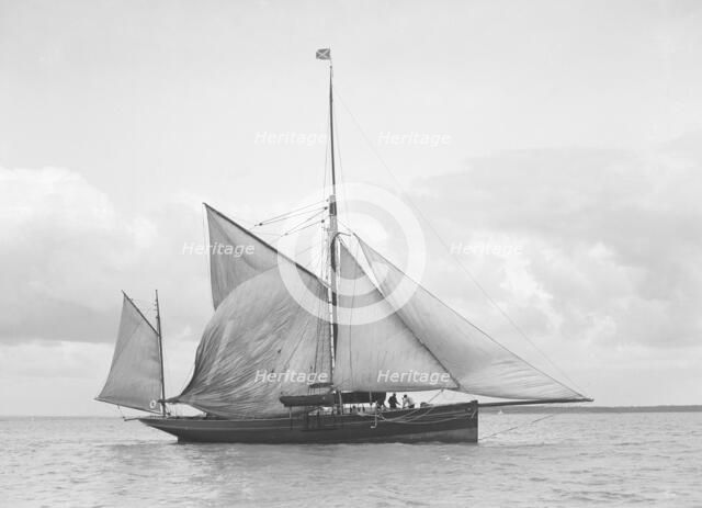 The yawl 'Roma' raising main sail, 1912. Creator: Kirk & Sons of Cowes.