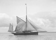 The yawl Roma raising main sail, 1912. Creator: Kirk & Sons of Cowes