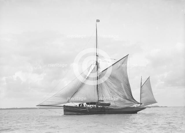 The yawl 'Roma' raising main sail, 1912. Creator: Kirk & Sons of Cowes.